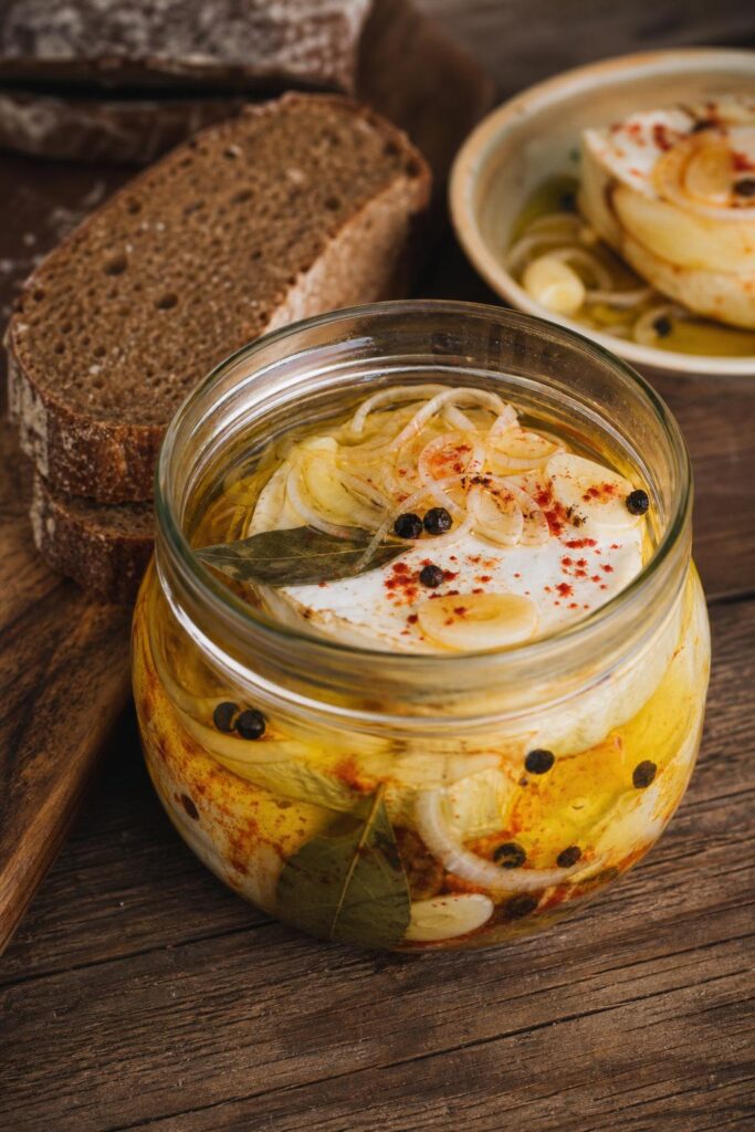 Pickled hermelín in a jar with onion and spices