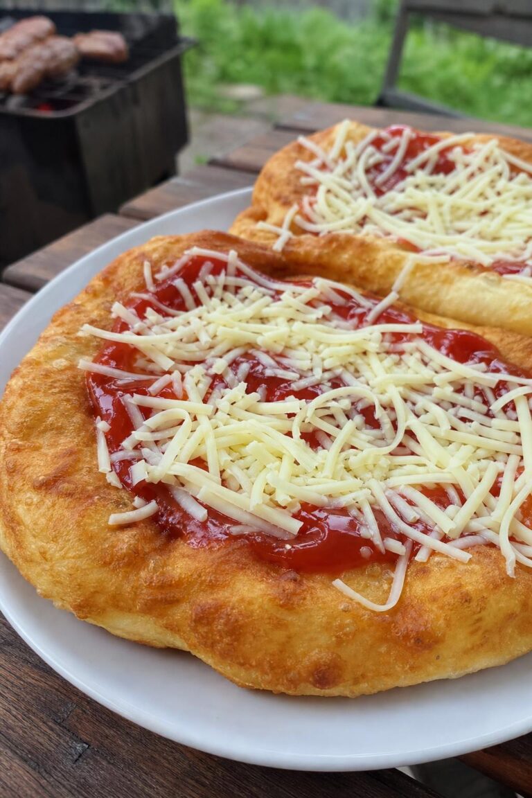Homemade langos with garlic, ketchup and cheese