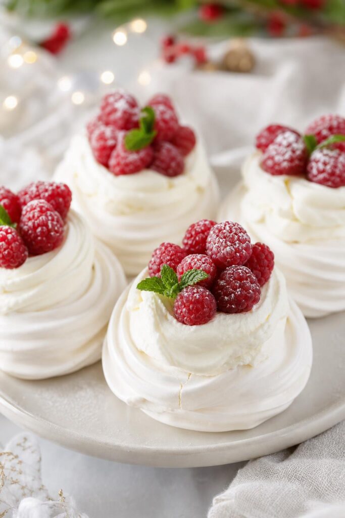 Mini pavlovas with raspberries and whipped cream